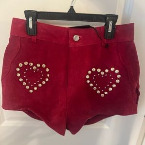 Rhinestone cowgirl red leather shorts with fringe trim on back. Never worn